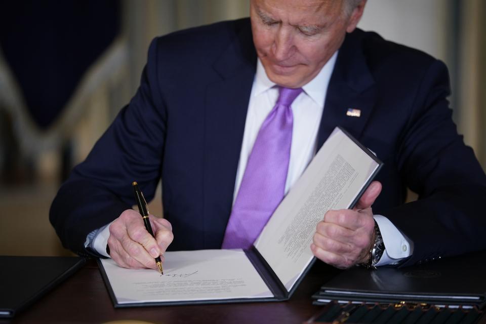 US President Joe Biden signs executive orders after speaking on racial equity in the State Dining Room of the White House in Washington, DC on January 26, 2021. (Photo by MANDEL NGAN / AFP) (Photo by MANDEL NGAN/AFP via Getty Images)