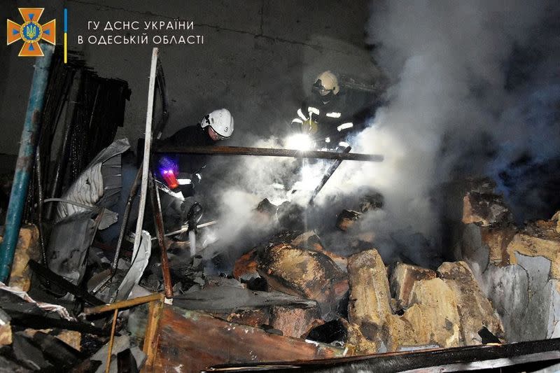 Firefighters work at a scene after a shelling in a location given as Odesa