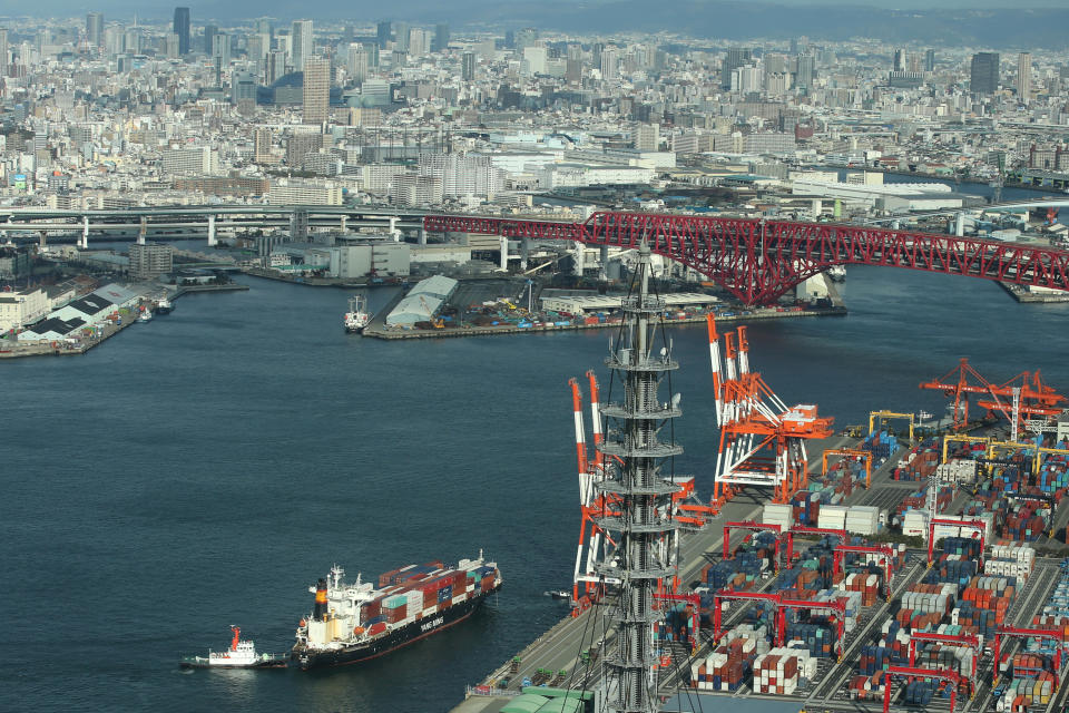 OSAKA, JAPAN - FEBRUARY 21:  Commercial buildings are seen over the Osaka Bay as container ship sails to container terminal near the Yumeshima Island on February 21, 2017, in Osaka, Japan. Osaka prefecture's political and business leaders announced their construction plan to develop the artificial island, Yumeshima Island or 'Island of Dreams' in the Osaka Bay as Japan's first large scale casino resorts including convention centers, hotels, shopping facilities and exhibition halls. According to the plan, the first area to be developed is approximately 70 of 390 hectares of the Yumeshima Island, which would be turned into the core of the integrated resort - casinos, hotels and exhibition halls. The estimated cost of construction and development is 824 billion Japanese yen (approx. 73 million USD.) The Japanese government passed the bill for the Integrated Resort (IR bill) to legalize casinos in the resort developments comprising hotels, entertainment, shopping, restaurants, and other tourist attractions, in the end of 2016.  (Photo by Buddhika Weerasinghe/Getty Images)