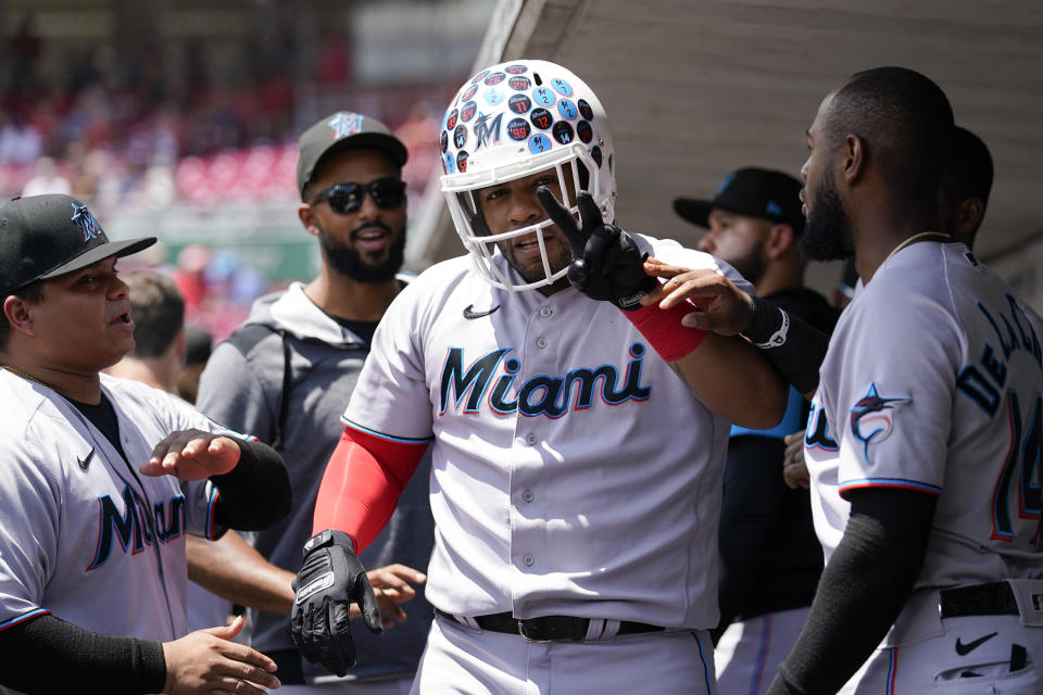 Miami Marlins' Jesus Aguilar, center, celebrates with teammates after hitting a two-run home run during the third inning of a baseball game against the Cincinnati Reds, Thursday, July 28, 2022, in Cincinnati. (AP Photo/Jeff Dean)