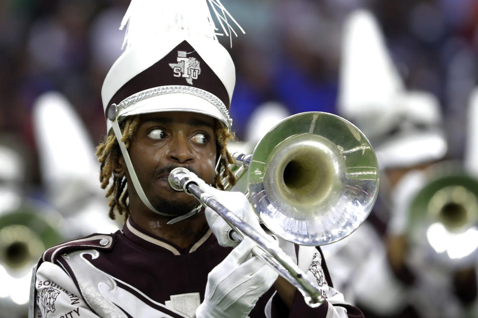 A trombone player with the Texas Southern University Ocean of Soul marching band watches the director as they perform during the 2023 National Battle of the Bands, a showcase for HBCU marching bands, held at NRG Stadium, Saturday, Aug. 26, 2023, in Houston. (AP Photo/Michael Wyke)