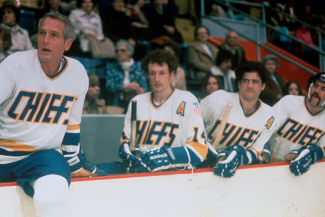 <p>Silver Screen Collection/Getty</p> Paul Newman (left), Yvan Ponton, Stephen Mendillo and Allan F Nicholls in 'Slap Shot'