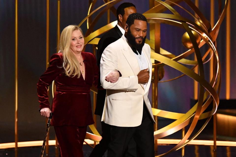actor anthony anderson and us actress christina applegate step onstage during the 75th emmy awards at the peacock theatre at la live in los angeles on january 15, 2024 photo by valerie macon afp