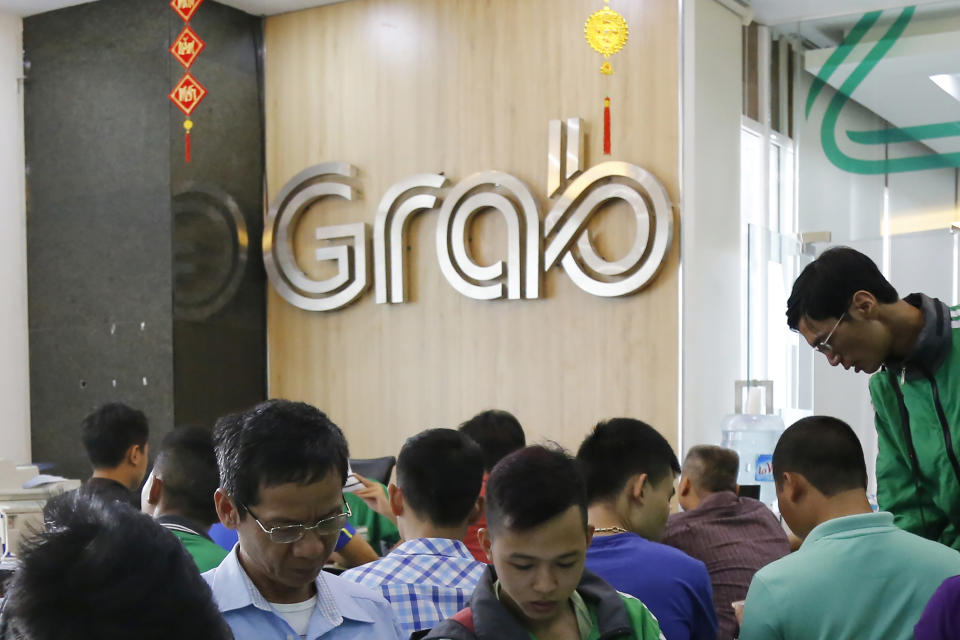 FILE - In this May 24, 2017, file photo, applicants fill in forms to join Grab Vietnam at the company's office in Hanoi, Vietnam. Southeast Asia’s largest ride-hailing company, Grab Holdings, said Tuesday, April 13, 2021 that it plans to merge with U.S.-based Altimeter Growth Capital in a deal that would value it at nearly $40 billion in preparation for an initial public offering in the U.S. (AP Photo/Tran Van Minh, File)