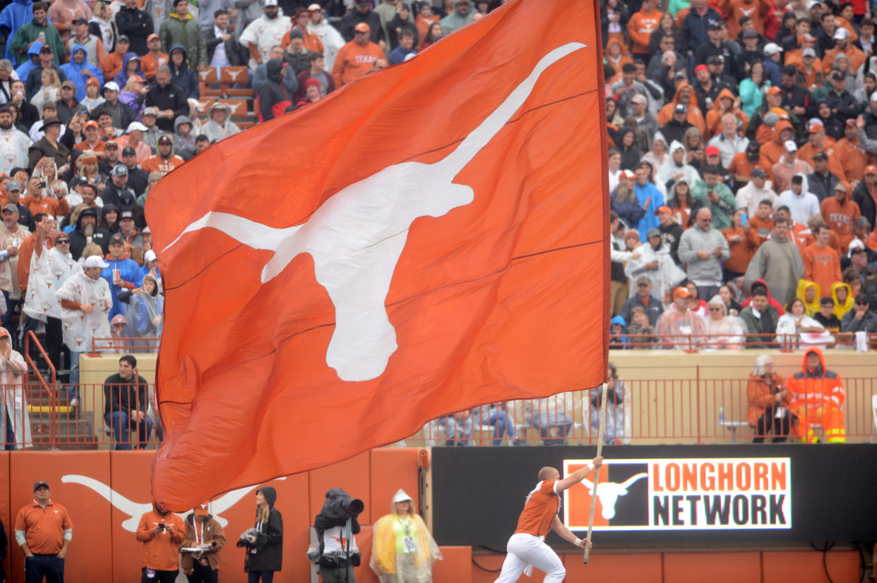 AUSTIN, TX - NOVEMBER 29: A Texas Longhorns spirit member runs with a flag during game against the Texas Tech Red Raiders on November 29, 2019 at Darrell K Royal-Texas Memorial Stadium in Austin, Texas. (Photo by John Rivera/Icon Sportswire via Getty Images)