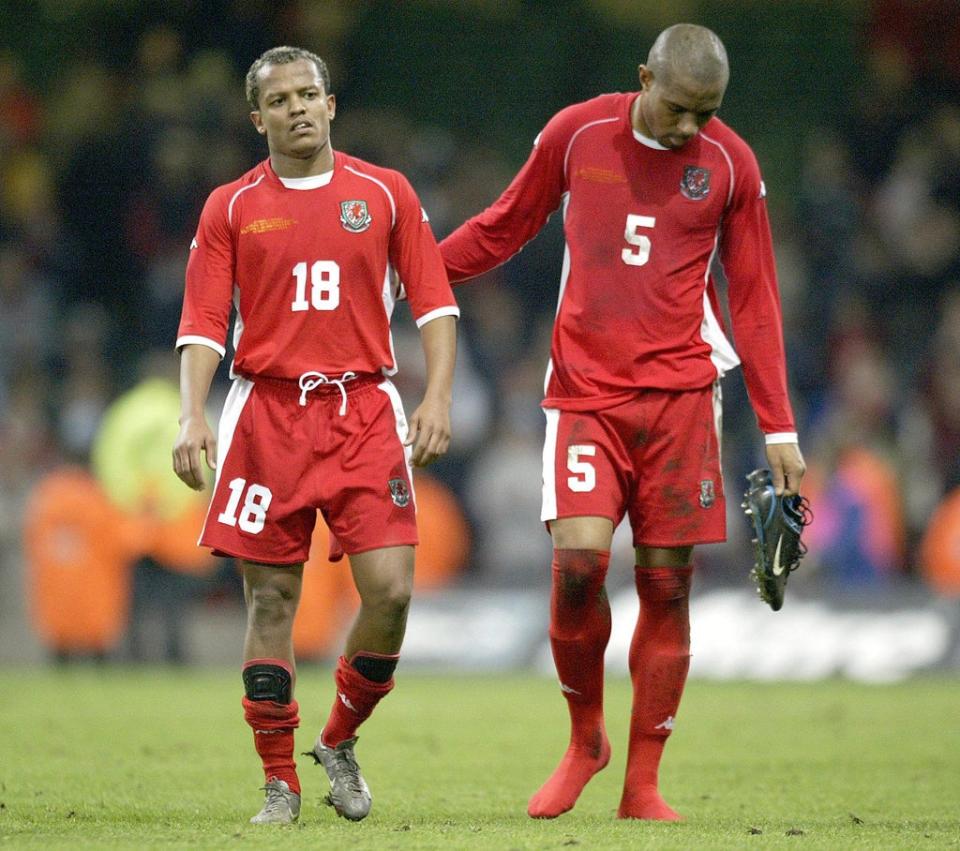 Robert Earnshaw, left, and Daniel Gabbidon, right, show their disappointment after Wales’ Euro 2004 play-off defeat to Russia in Cardiff (Nick Potts/PA) (PA Archive)