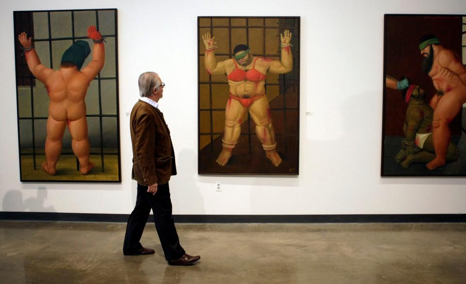 Colombian artist Fernando Botero looks over his work at a first complete U.S. showing of "Art of Confrontation," his paintings and drawings on Abu Ghraib prison at American University Museum in Washington, Nov. 5, 2007.