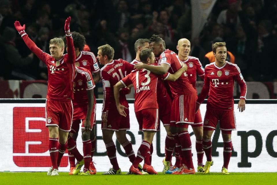 Bayern's Toni Kroos, left, celebrates with the team after scoring his side's first goal during the first division Bundesliga soccer match between Hertha BSC and FC Bayern Munich in Berlin, Tuesday, March 25, 2014. (AP Photo/Markus Schreiber)