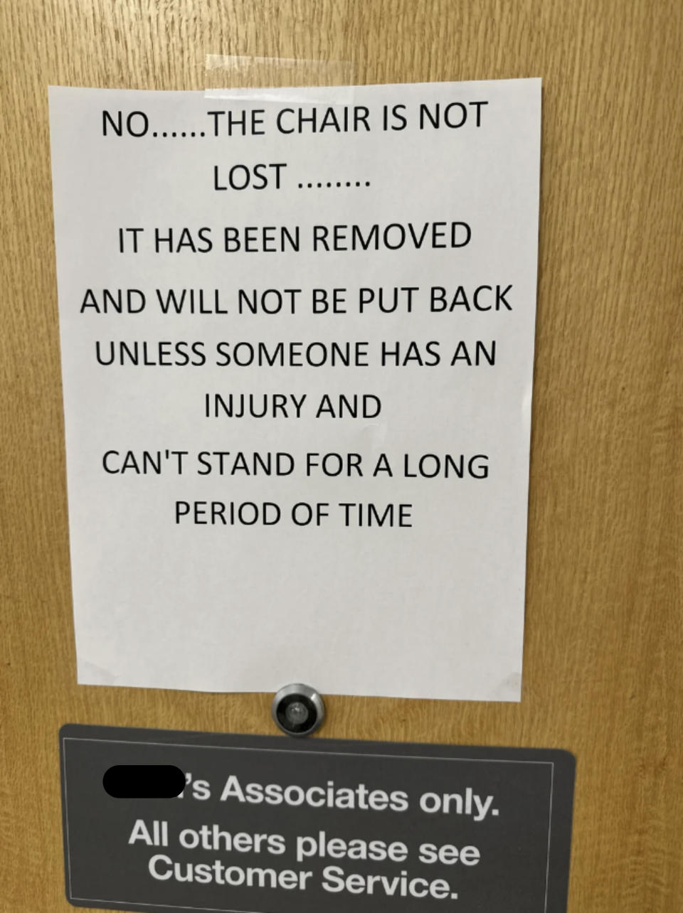 Sign on a door reads: "The chair is not lost. It has been removed and will not be back until someone has an injury for a period of time. Kohl's Associates only."