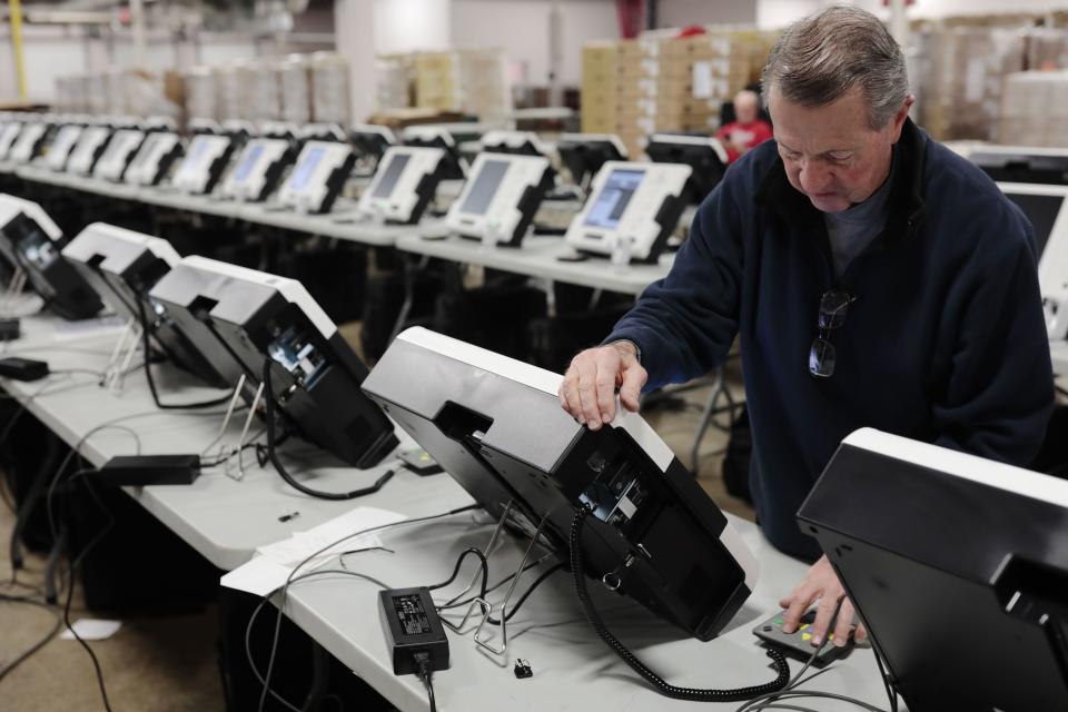 Scott Thomas, a logistics technician, prepares to boot up new voting machines as he works on Friday, February 1, 2019 at the Franklin County Board of Elections in Columbus, Ohio.