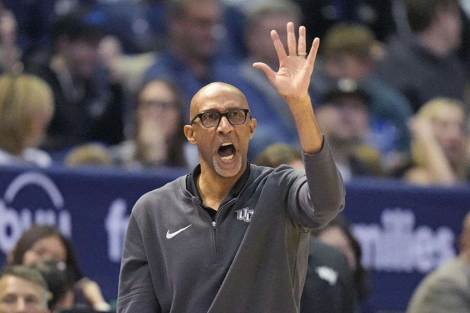 Central Florida head coach Johnny Dawkins directs his team during the first half of an NCAA college basketball game against BYU Tuesday, Feb. 13, 2024, in Provo, Utah. (AP Photo/Rick Bowmer)