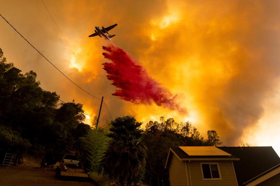 An air tanker drops retardant as the LNU Lightning Complex fires tear through the Spanish Flat community in unincorporated Napa County, Calif., Tuesday, Aug. 18, 2020. Fire crews across the region scrambled to contain dozens of wildfires sparked by lightning strikes as a statewide heat wave continues.