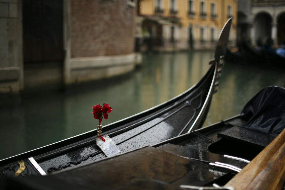 Gondolas are parked on a rainy day in Venice, Sunday, March 1, 2020. Venice in the time of coronavirus is a shell of itself, with empty piazzas, shuttered basilicas and gondoliers idling their days away. The cholera epidemic that raged quietly through Venice in Thomas Mann's fictional "Death in Venice" has been replaced by a real life fear of COVID-19. (AP Photo/Francisco Seco)