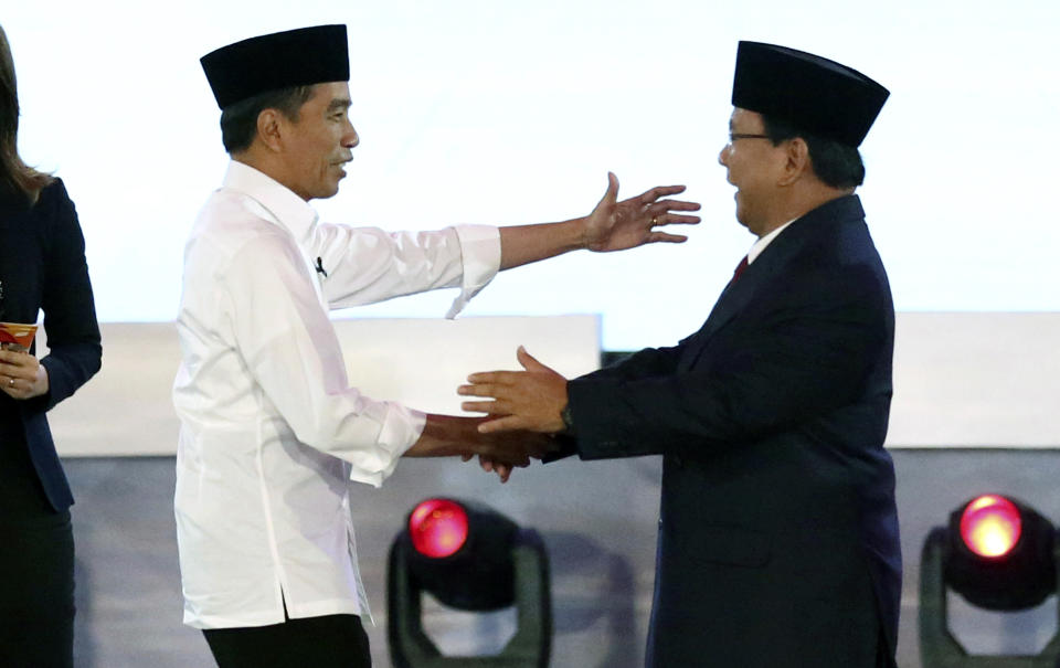 Indonesian President Joko Widodo, left, and his contender Prabowo Subianto, shake hands after a televised debate in Jakarta, Indonesia, Thursday, Jan. 17, 2019. Indonesia is gearing up to hold its presidential election on April 17 that will pit in the incumbent against the former general.(AP Photo /Tatan Syuflana)