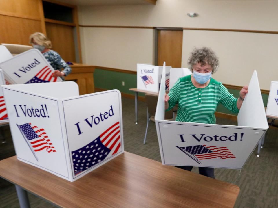 Marty Goetz, right, and Diane White, prepare the voting screens as they start to set up a polling place Monday, June 1, 2020, for the voting for Tuesday's Pennsylvania primary in Jackson Township near Zelienople, Pa. (AP Photo/Keith Srakocic)