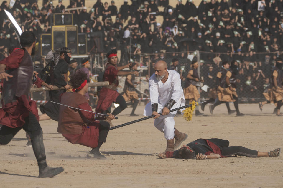 Shiite Muslims re-enact the seventh century battle of Karbala during activities marking the holy day of Ashoura, in the Shiite neighborhood of Sadr City, Baghdad, Iraq, Saturday, July. 29, 2023. Ashoura is the annual Shiite Muslim commemoration marking the death of Imam Hussein, the grandson of the Prophet Muhammad, at the Battle of Karbala in present-day Iraq in the 7th century. (AP Photo/Hadi Mizban)