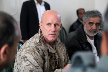 Vice Adm. Robert S. Harward, commanding officer of Combined Joint Interagency Task Force 435, speaks to an Afghan official during his visit to Zaranj, Afghanistan, in this January 6, 2011 handout photo. Sgt. Shawn Coolman/U.S. Marines/Handout via REUTERS