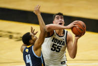 Iowa center Luka Garza (55) drives to the basket ahead of Southern University guard Isaiah Rollins (4) during the first half of an NCAA college basketball game, Friday, Nov. 27, 2020, in Iowa City, Iowa. (AP Photo/Charlie Neibergall)