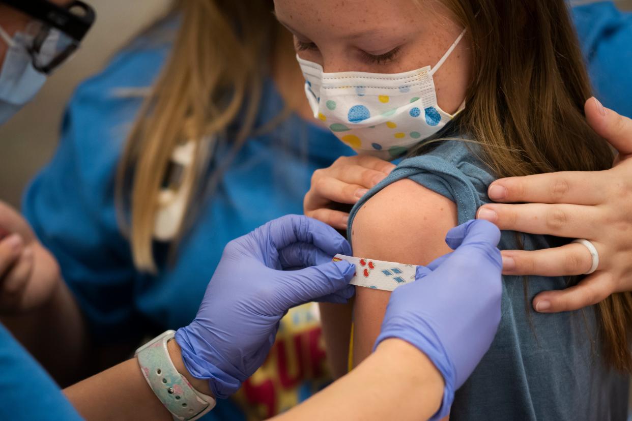 Marin Ackerman, 10, of Upper Arlington, gets a bandage after receiving a dose of the Pfizer-BioNTech COVID-19 vaccine during a clinic for kids ages 5 to 11-year-olds on Nov. 3 at Nationwide Children's Hospital. The FDA recently authorized use of the Pfizer-BioNTech COVID-19 vaccine for use in younger children.