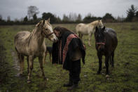 Mapuche leader and mediator Andres Antivil Alvarez, who works to ensure non-Natives understand how nature matters to his people, greets his horse Chayane in Rengalil, southern Chile, on Saturday, July 9, 2022. "The world is not loot. Everything that's outside is also inside ourselves," Alvarez says. (AP Photo/Rodrigo Abd)