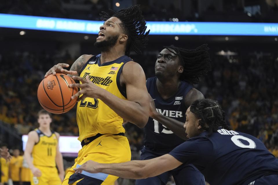Xavier's Trey Green fouls Marquette's David Joplin during the first half of an NCAA college basketball game Sunday, Feb. 25, 2024, in Milwaukee. (AP Photo/Morry Gash)