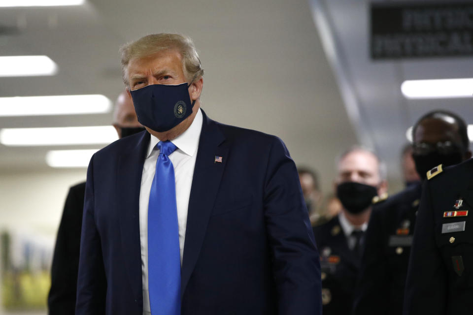 President Donald Trump wears a face mask as he walks down a hallway during a visit to Walter Reed National Military Medical Center in Bethesda, Md., Saturday, July 11, 2020. (AP Photo/Patrick Semansky)