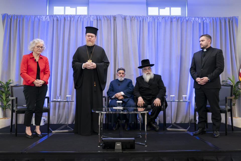 Former US ambassador to Ukraine Marie Yovanovitch, archbishop Yevstratiy Zorya, Mufti Akhmed Tamim, Rabbi Yaakov Dov Bleich and Bishop Ivan Rusyn, left to right, hold a moment of silence in remembrance of Ukrainians killed in the ongoing war with Russia, before a panel discussion on religion freedoms, Monday, Oct. 30, 2023, in Washington. (AP Photo/Stephanie Scarbrough)