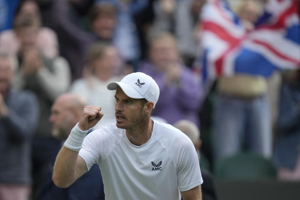 Britain's Andy Murray celebrates winning the third set during the singles tennis match against John Isner of the US on day three of the Wimbledon tennis championships in London, Wednesday, June 29, 2022. (AP Photo/Alastair Grant)