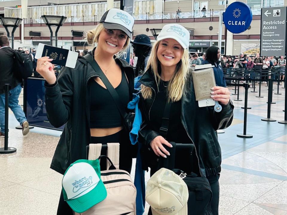 Jordan Carlyle and Christen Puckett are holding their passports and have their travel bags with them