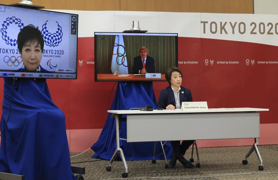 International Olympic Committee president Thomas Bach (virtually) delivers an opening speech while Tokyo 2020 Organizing Committee president Seiko Hashimoto and Tokyo Governor Yuriko Koike (virtually) listen.