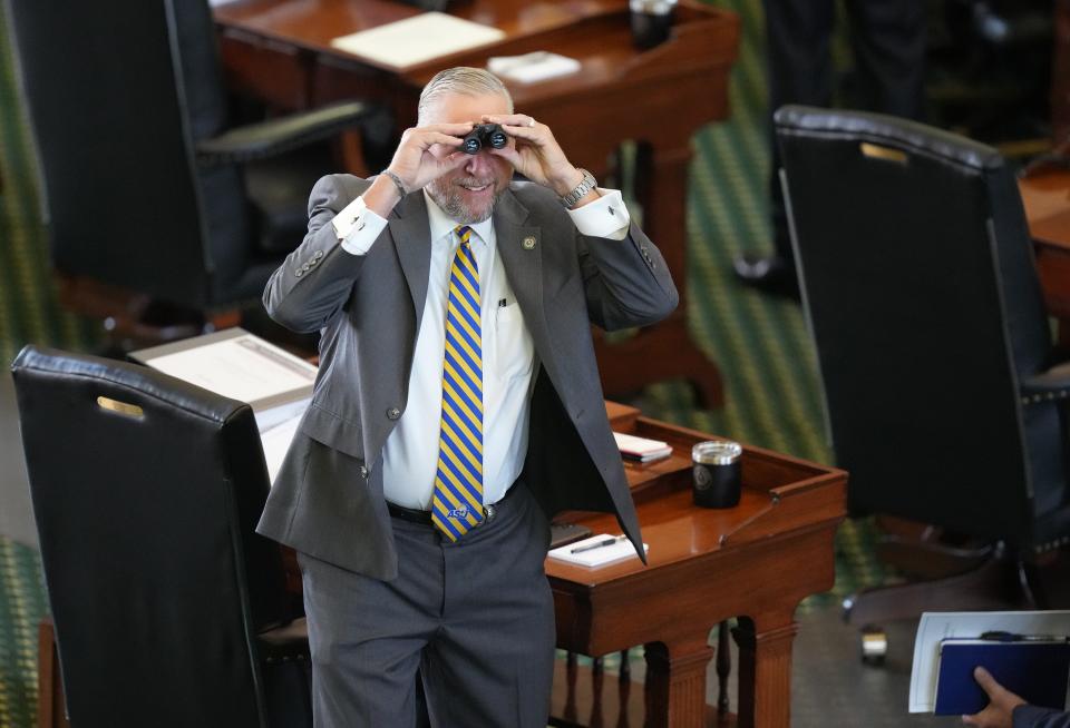 Sen. Drew Springer, R - Muenster, looks through binoculars at the gallery at the impeachment trial of Attorney General Ken Paxton at the Capitol on Tuesday September 5, 2023.