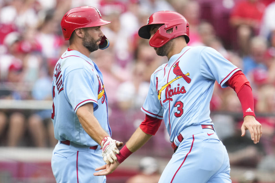 St. Louis Cardinals' Dylan Carlson (3) celebrates with Paul Goldschmidt after scoring on a single hit by Tyler O'Neill during the third inning of a baseball game against the Cincinnati Reds, Saturday, July 23, 2022, in Cincinnati. (AP Photo/Jeff Dean)