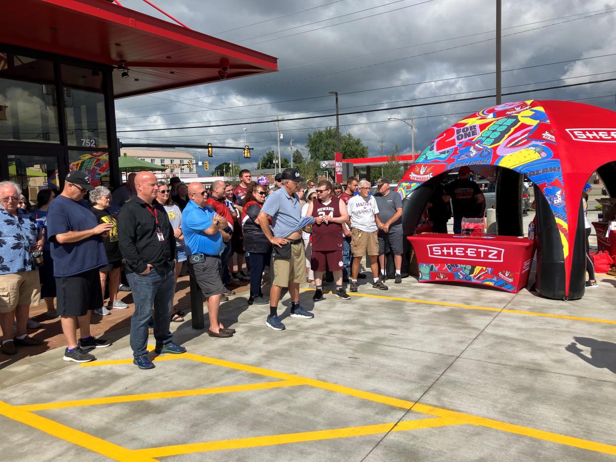 A crowd waits to learn who won the $2,500 Sheetz gift card at Tuesday morning's grand opening of the restaurant, convenience store and gas station on the corner of Hebron Road and Oberlin Drive in Heath.