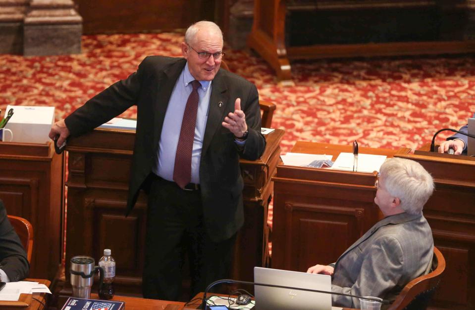 Iowa Sen. Ken Rozenboom, left, speaks with Sen. Jeff Taylor during a recess in the Senate chambers at the Iowa Capitol in Des Moines on Thursday, April 1, 2021.