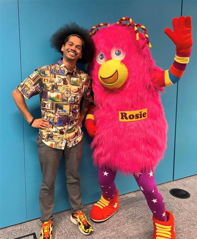 Mychal Theets visits the Des Moines Library and poses with Rosie Reader.
