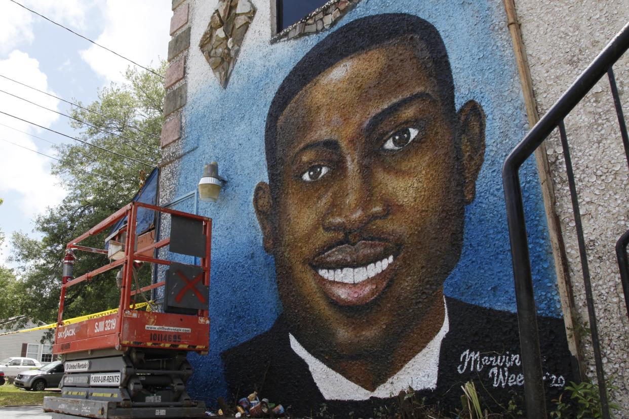 FILE - A recently painted mural of Ahmaud Arbery is displayed in Brunswick, Ga., on May 17, 2020, where the 25-year-old man was shot and killed in February. Months after they were sentenced to life in prison for murder, the three white men who chased and killed Ahmaud Arbery in a Georgia neighborhood faced a second round of criminal penalties Monday, Aug. 8, 2022, for federal hate crimes committed in the deadly pursuit of the 25-year-old Black man. (AP Photo/Sarah Blake Morgan, File)