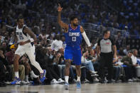 LA Clippers forward Paul George (13) celebrates after making a 3-pointer during the first half of Game 1 of an NBA basketball first-round playoff series against the Dallas Mavericks in Los Angeles, Sunday, April 21, 2024. (AP Photo/Ashley Landis)