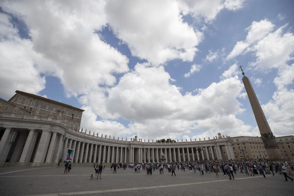 People gather in St. Peter's Square as Pope Francis delivers his Angelus prayer from the window, top, of his studio overlooking the square, Sunday, June 14, 2020. (AP Photo/Alessandra Tarantino)