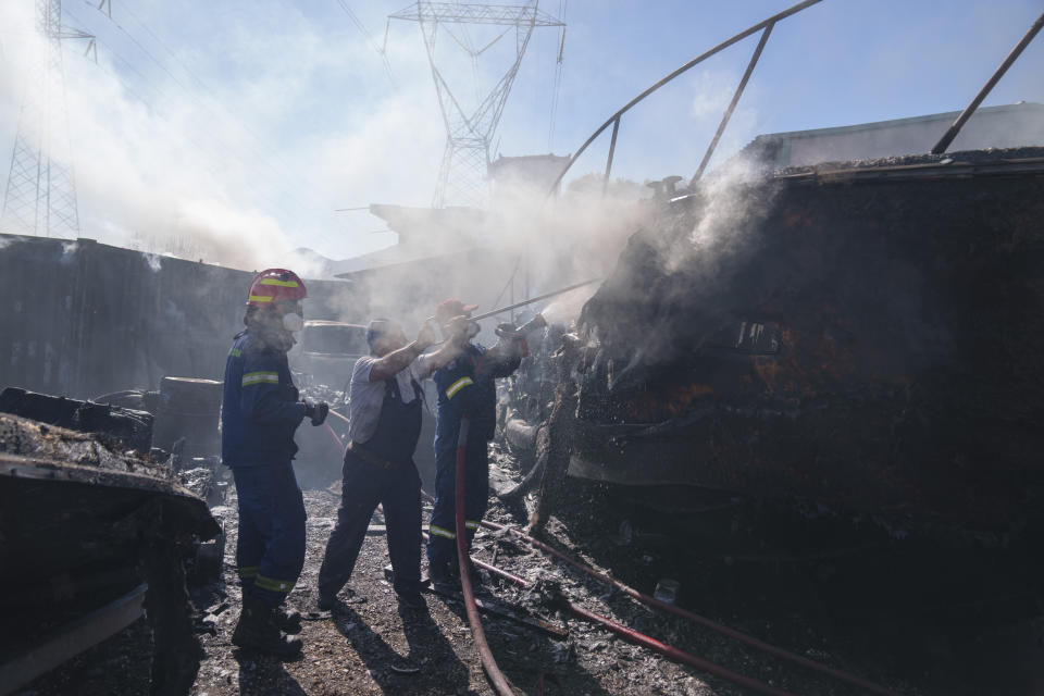 Firefighters try to extinguish a yacht on fire in Koropi suburb, eastern part of Athens, Wednesday, June 19, 2024. Scores of Greek firefighters and water-bombing aircraft were trying to contain a large wildfire on the fringes of Athens that forced authorities to issue evacuation orders Wednesday for two nearby settlements. (AP Photos/Petros Giannakouris)