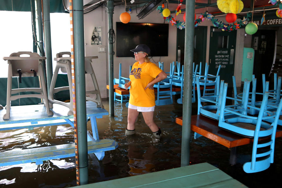 Robyn Iacona-Hilbert walks through her flooded business after Hurricane Barry in Mandeville, Louisiana, U.S. July 13, 2019.  REUTERS/Jonathan Bachman