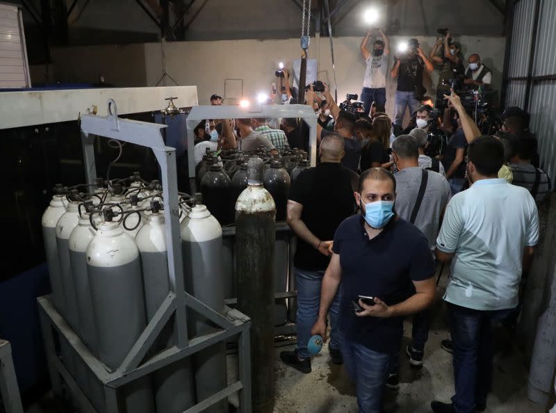 Journalists are seen inside a building during a Hezbollah guided tour in the Jnah neighborhood of Beirut