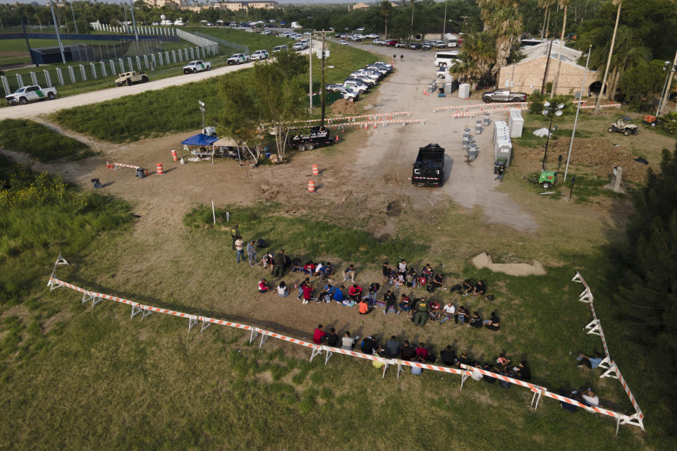 FILE - Migrants are processed in a field after crossing the the Rio Grande at the United States-Mexico border, Thursday, May 11, 2023, in Brownsville, Texas. An 8-year-old girl from Panama born with heart problems died Wednesday, at a Border Patrol station , in the Rio Grande Valley, one of the busiest corridors for migrant crossings, the second death of a child from Latin America in U.S. government custody in two weeks. (AP Photo/Julio Cortez, File)