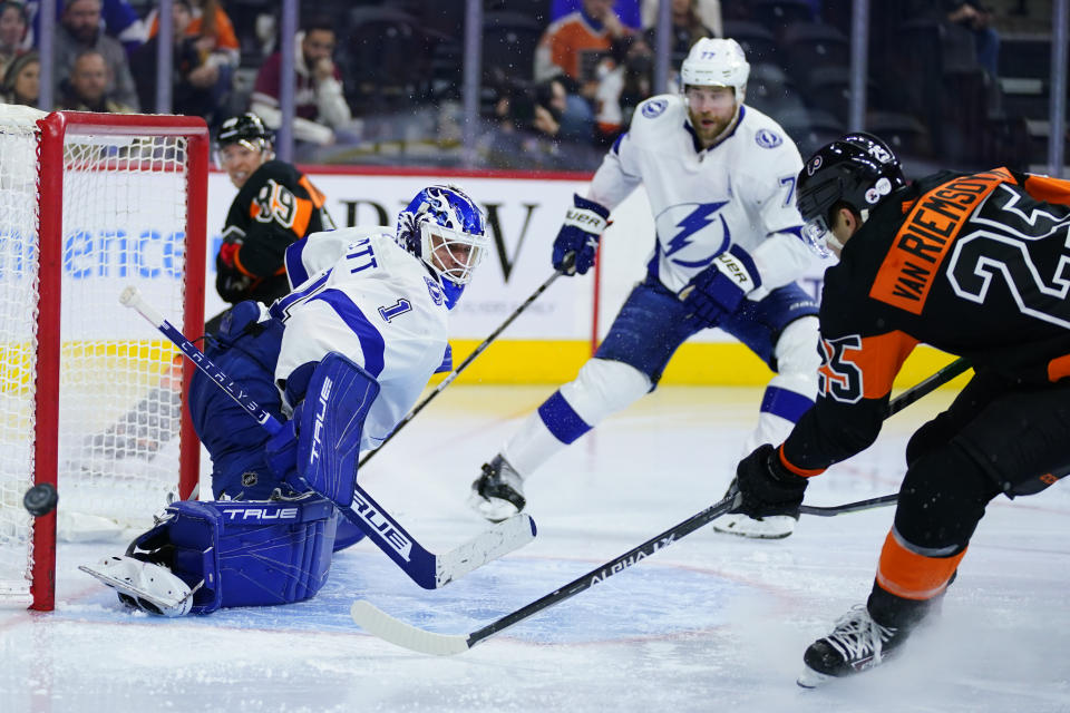 Philadelphia Flyers' James van Riemsdyk, right, cannot get a shot past Tampa Bay Lightning's Brian Elliott, left, during the second period of an NHL hockey game, Sunday, Dec. 5, 2021, in Philadelphia. (AP Photo/Matt Slocum)