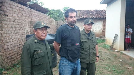 Peruvian Martin Belaunde Lossio is pictured after his capture by police and military forces in the Itenez Province in the Beni Department, in this picture provided by the Agencia Boliviana de Informacion (ABI) on May 28, 2015. REUTERS/ABI/Bolivian Information Agency/Handout ATTENTION EDITORS - THIS IMAGE WAS PROVIDED BY A THIRD PARTY. FOR EDITORIAL USE ONLY. NOT FOR SALE FOR MARKETING OR ADVERTISING CAMPAIGNS. THIS PICTURE IS DISTRIBUTED EXACTLY AS RECEIVED BY REUTERS, AS A SERVICE TO CLIENTS TPX IMAGES OF THE DAY