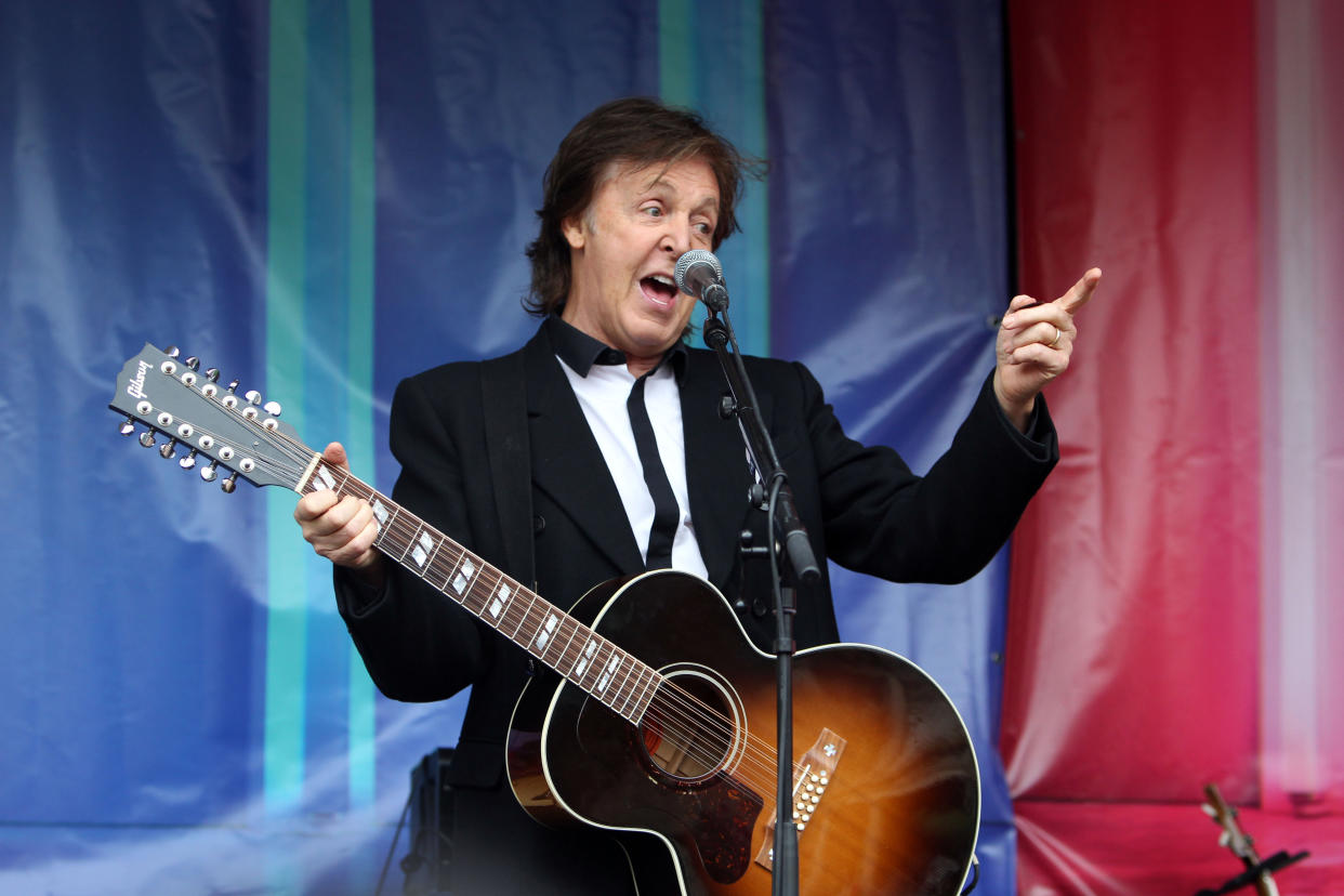 Sir Paul McCartney plays songs from his new album during a surprise concert in Covent Garden, London.