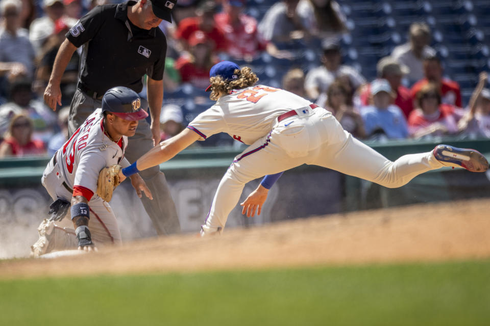 Washington Nationals' Starlin Castro (13) is safe at third before Philadelphia Phillies third baseman Alec Bohm (28) can make the tag during the sixth inning of a baseball game, Wednesday, June 23, 2021, in Philadelphia. (AP Photo/Laurence Kesterson)