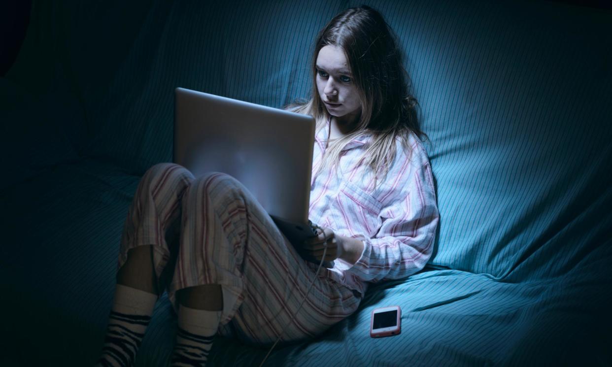 <span>‘She starts to sit absent-mindedly, clicking and scrolling alone every evening after school.’</span><span>Photograph: Ben Welsh/Getty Images</span>