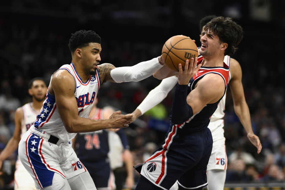 Philadelphia 76ers forward KJ Martin, left, tries to get the ball from Washington Wizards forward Deni Avdija, right, during the first half of an NBA basketball game Saturday, Feb. 10, 2024, in Washington. (AP Photo/Nick Wass)