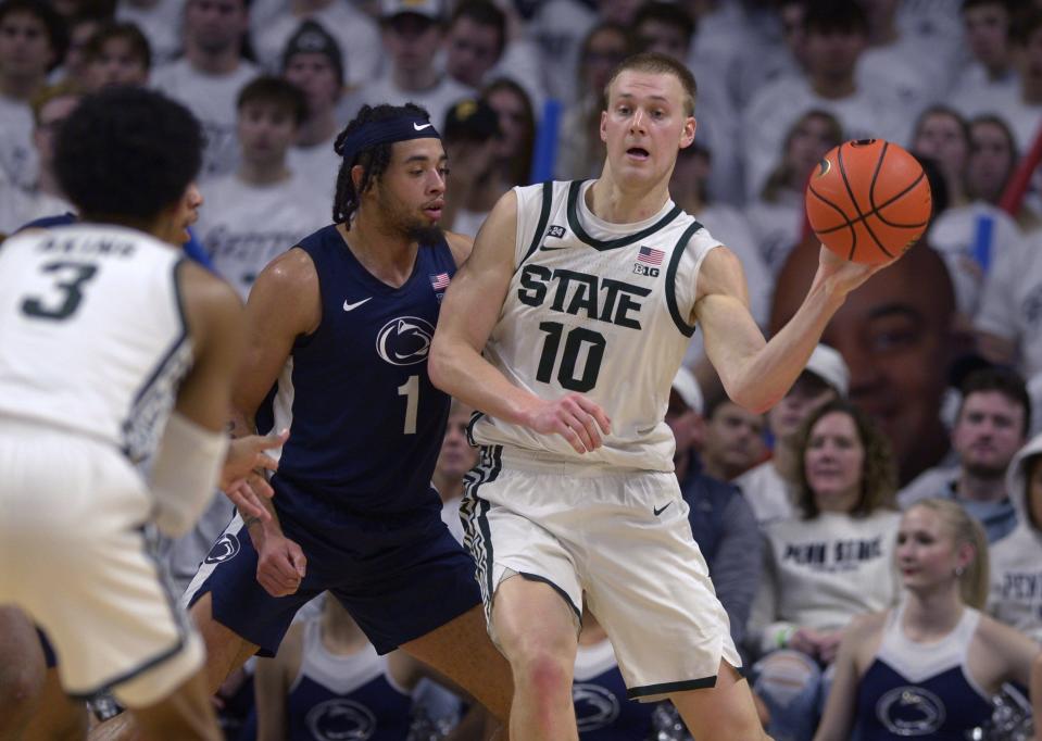 Michigan State's Joey Hauser (10) is defended by Penn State's Seth Lundy (1) during the first half of an NCAA college basketball game Wednesday, Dec. 7, 2022, in State College, Pa.