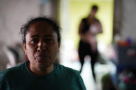 Iracema Figueroa, left, of Honduras, looks on at a shelter for migrants Friday, May 20, 2022, in Tijuana, Mexico. Figueroa has spent two years trying to reach a safe place for her family and was praying the judge would lift the order. Figueroa left Honduras in 2019 after gangs killed her uncle and threatened her three sons. (AP Photo/Gregory Bull)